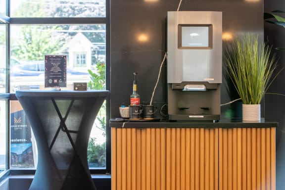 a desk with a computer on top of it next to a window