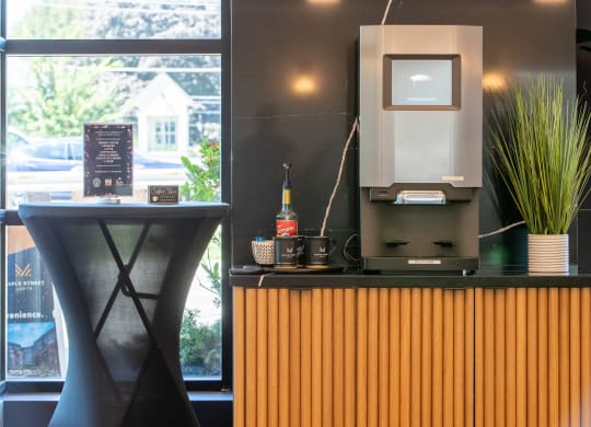 a desk with a computer on top of it next to a window