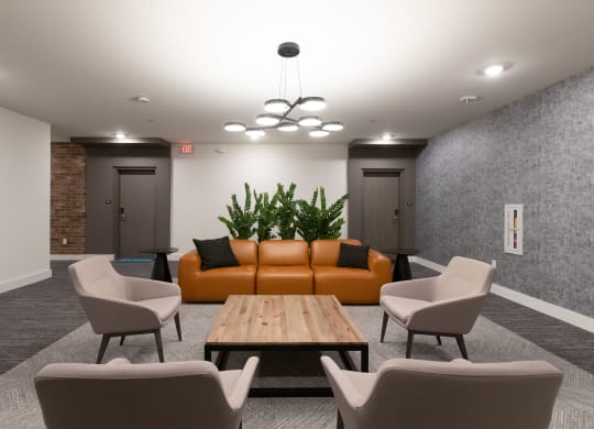 a room with a couch table chairs and a chandelier