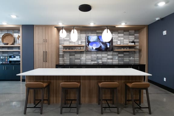 a kitchen with a large island and a tv on the wall