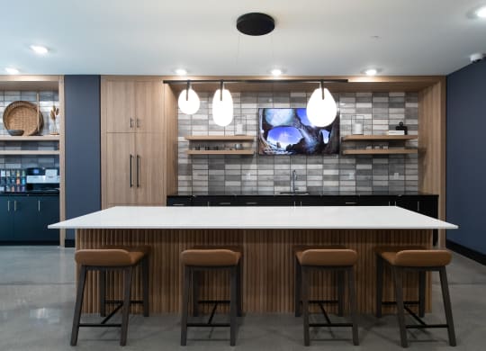 a kitchen with a large island and a tv on the wall