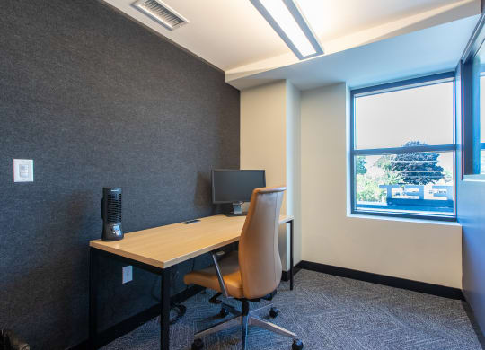 a workspace with a computer monitor and chair