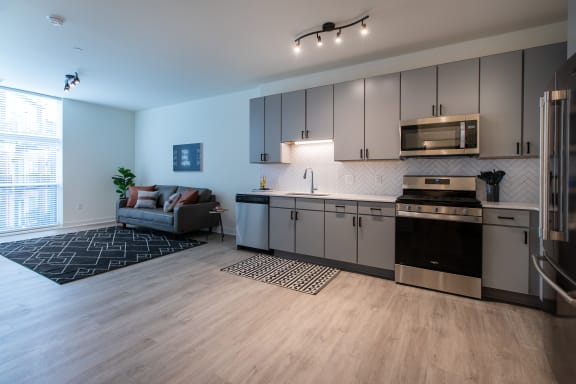 a kitchen and living room in a two bedroom apartment